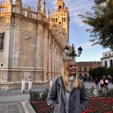 Elisabeth poses in front of a building in Spain.