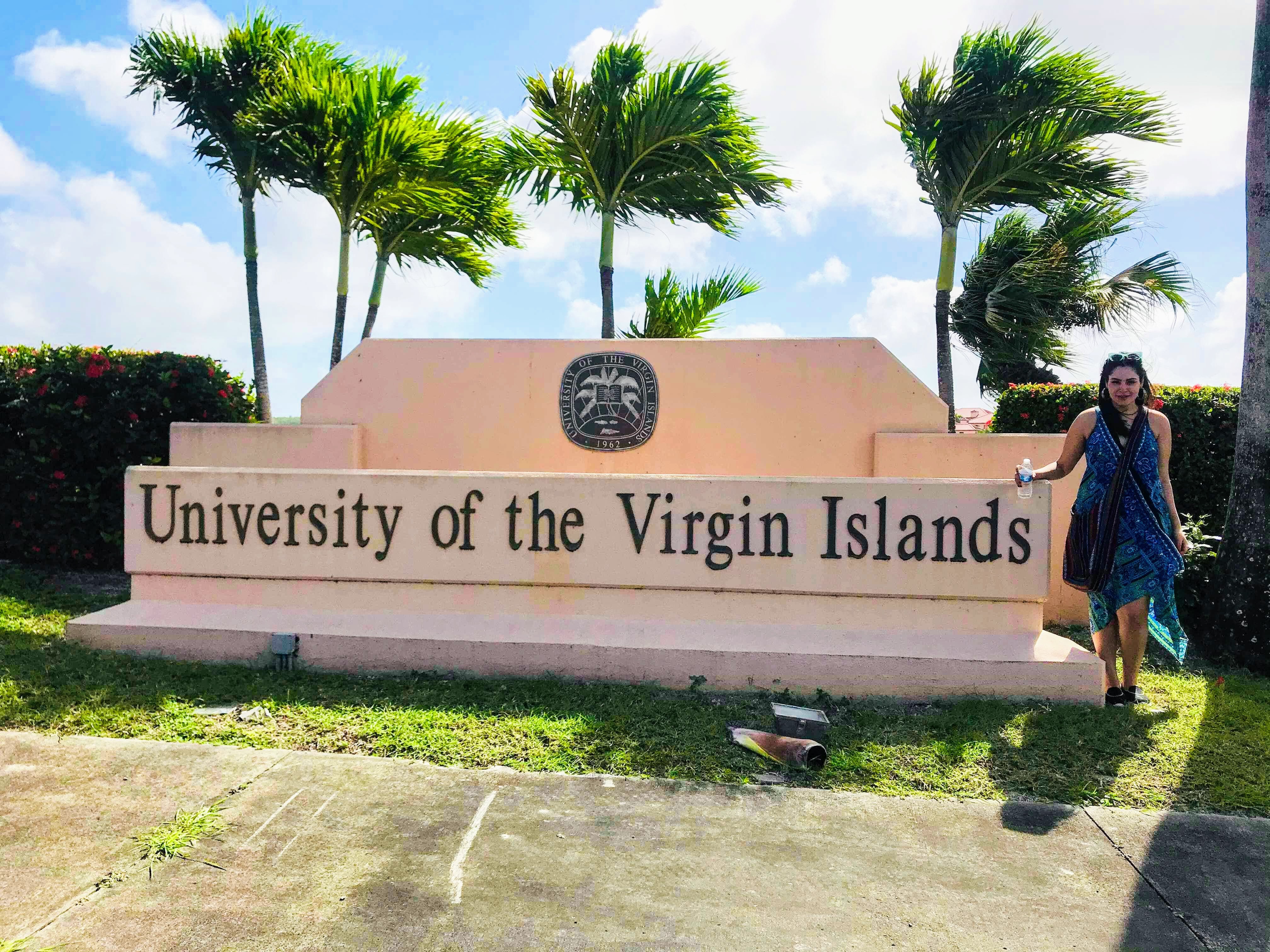 Student stands in front of University of the US Virgin Islands sign