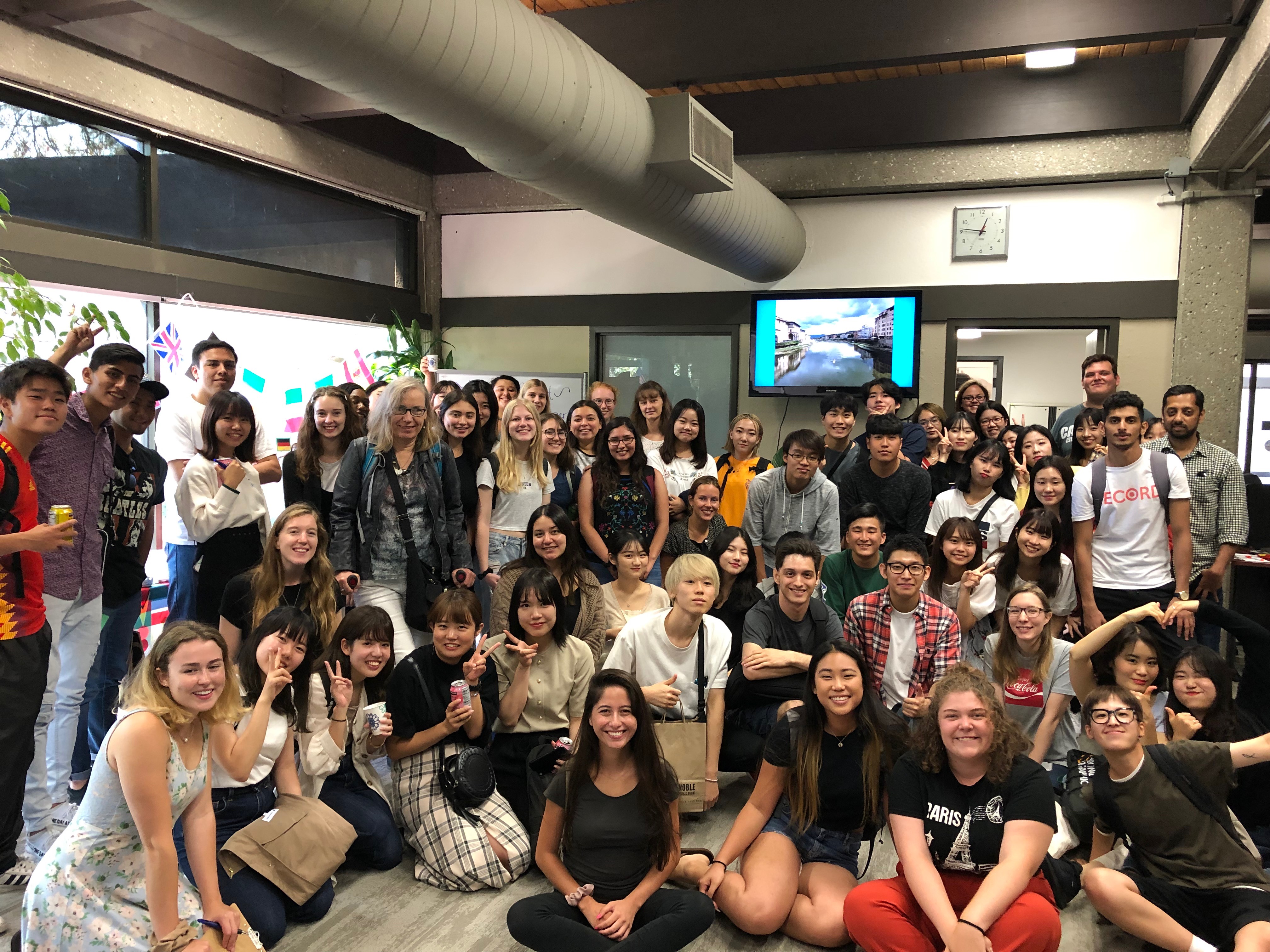 Students stand in a group and smile for the camera