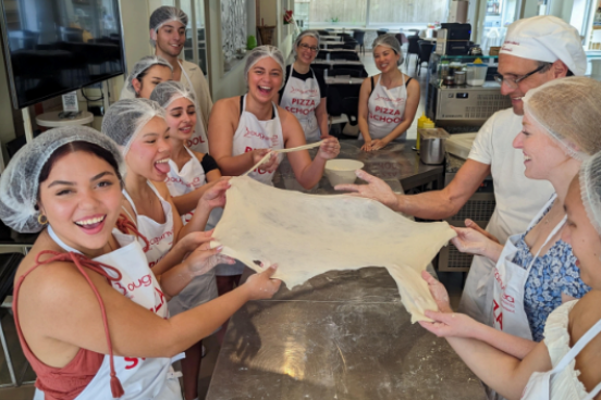 group of students pulling dough
