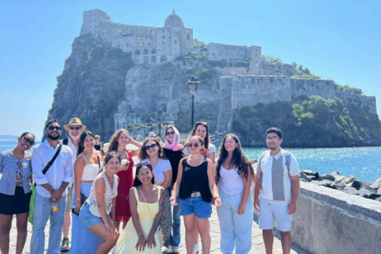 group of students in front of scenic Italy 