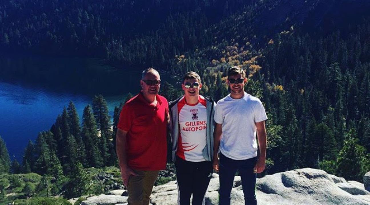 Evan and his family near a lake