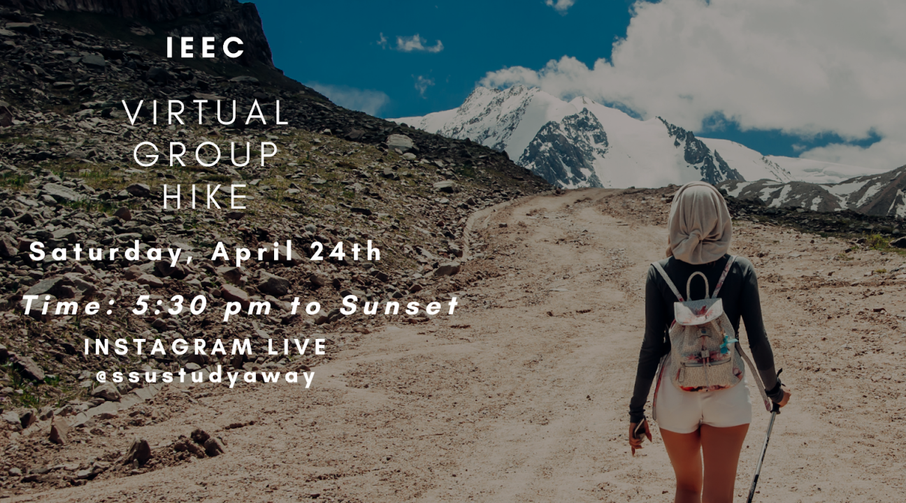 A photo of a person walking uphill with snowy mountains in the background with info on the Virtual Group Hike event by IEEC