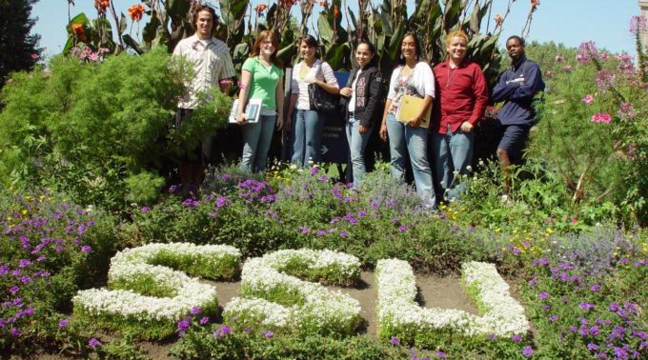 Students standing in a garden