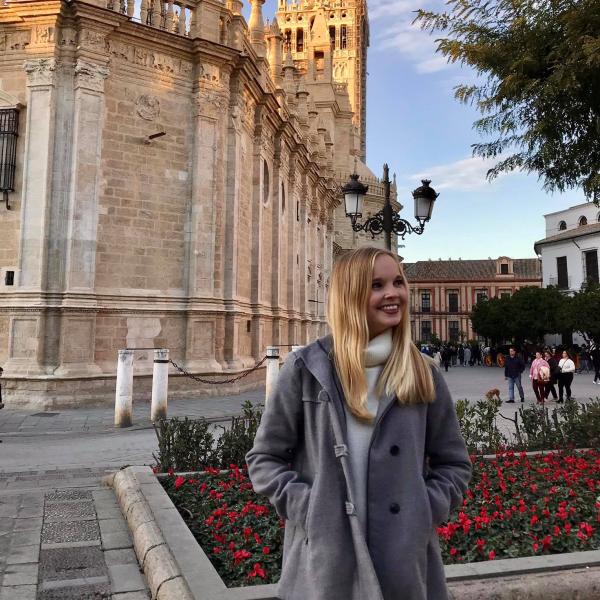 Elisabeth poses in front of a building in Spain.