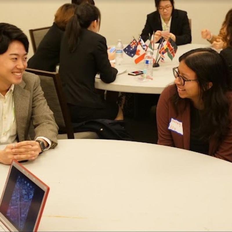 two individuals chatting at a table