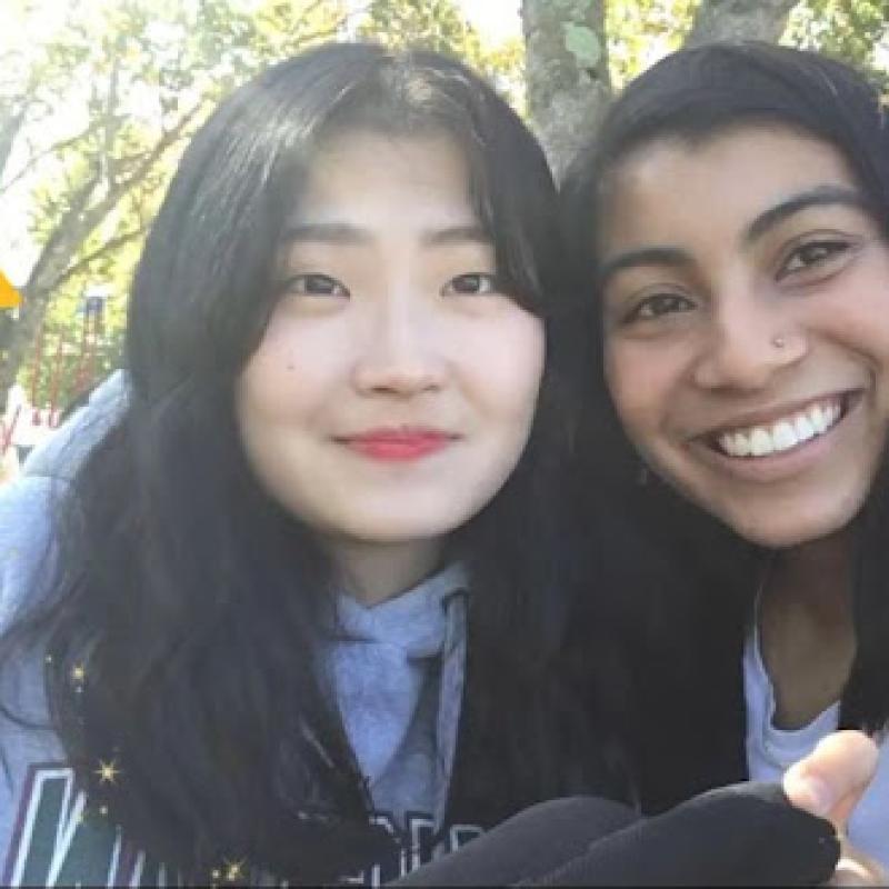 Two ladies taking a smiling selfie