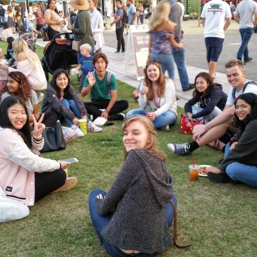 Students sitting on grass.