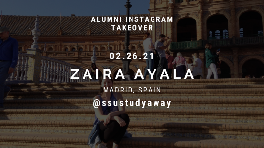 Zaira sitting on the steps of a bridge with other tourists around